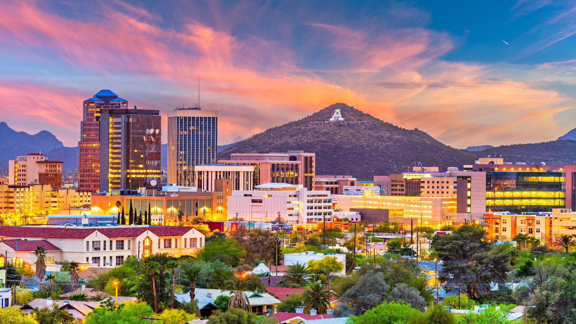 Tucson, Arizona skyline with mountain and colorful sunset backdrop